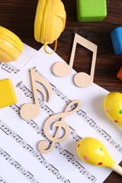 Baby song concept. Wooden notes, music sheet and toys on table, flat lay