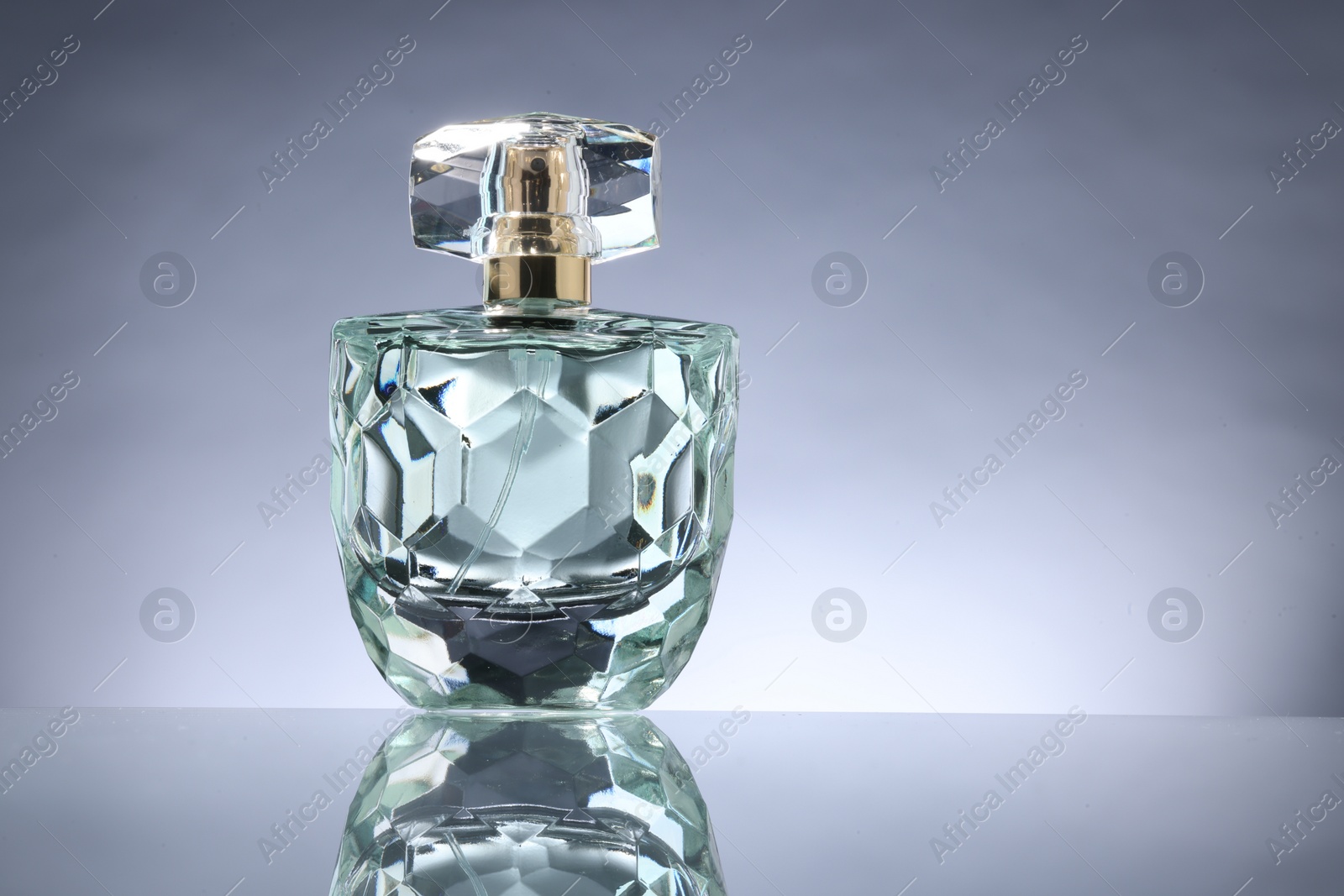 Photo of Luxury women's perfume in bottle on grey background. Space for text