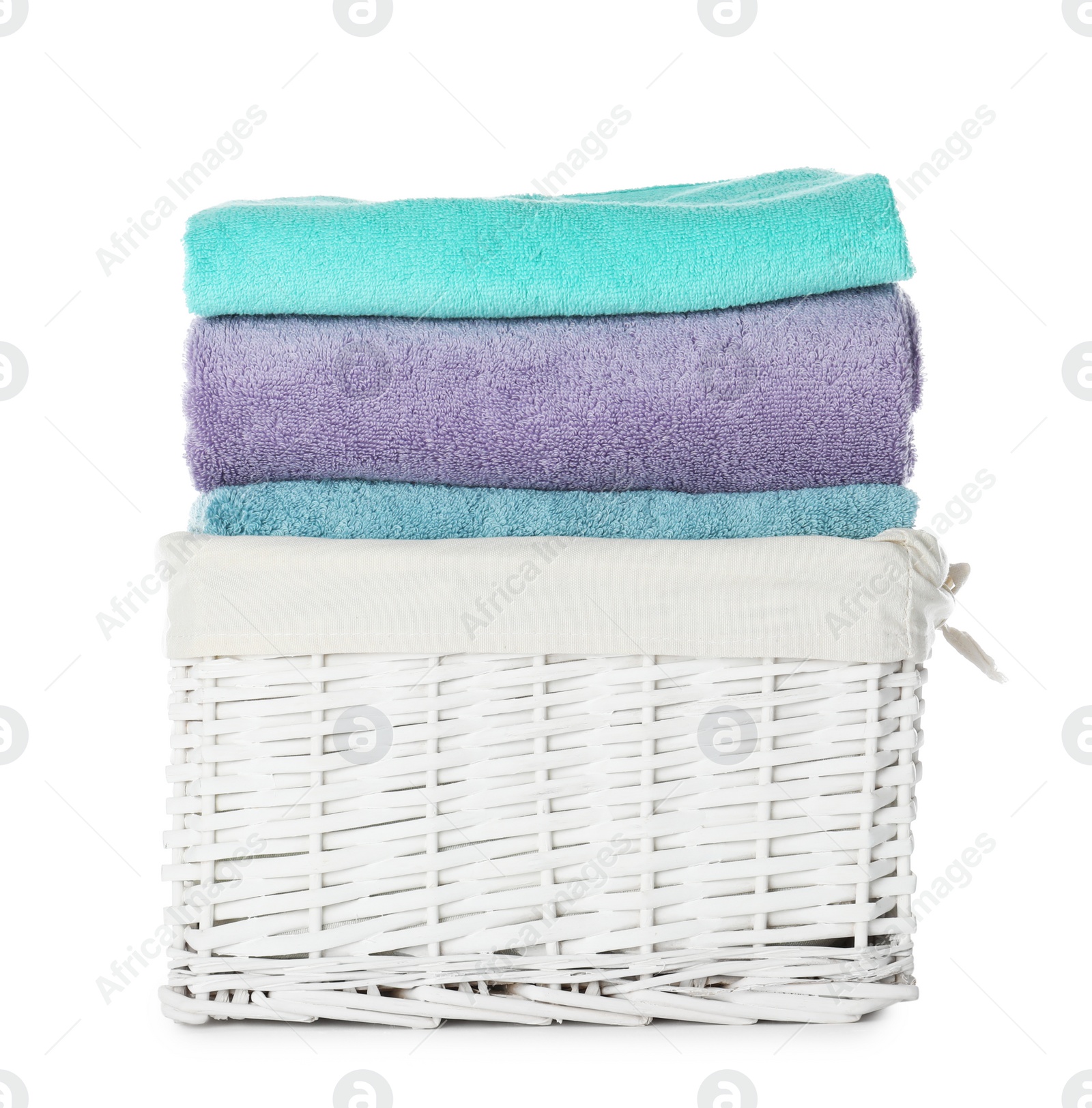 Photo of Folded towels in wicker basket on white background. Laundry day