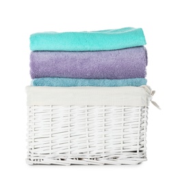 Photo of Folded towels in wicker basket on white background. Laundry day