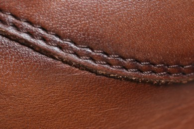Brown natural leather with seams as background, top view