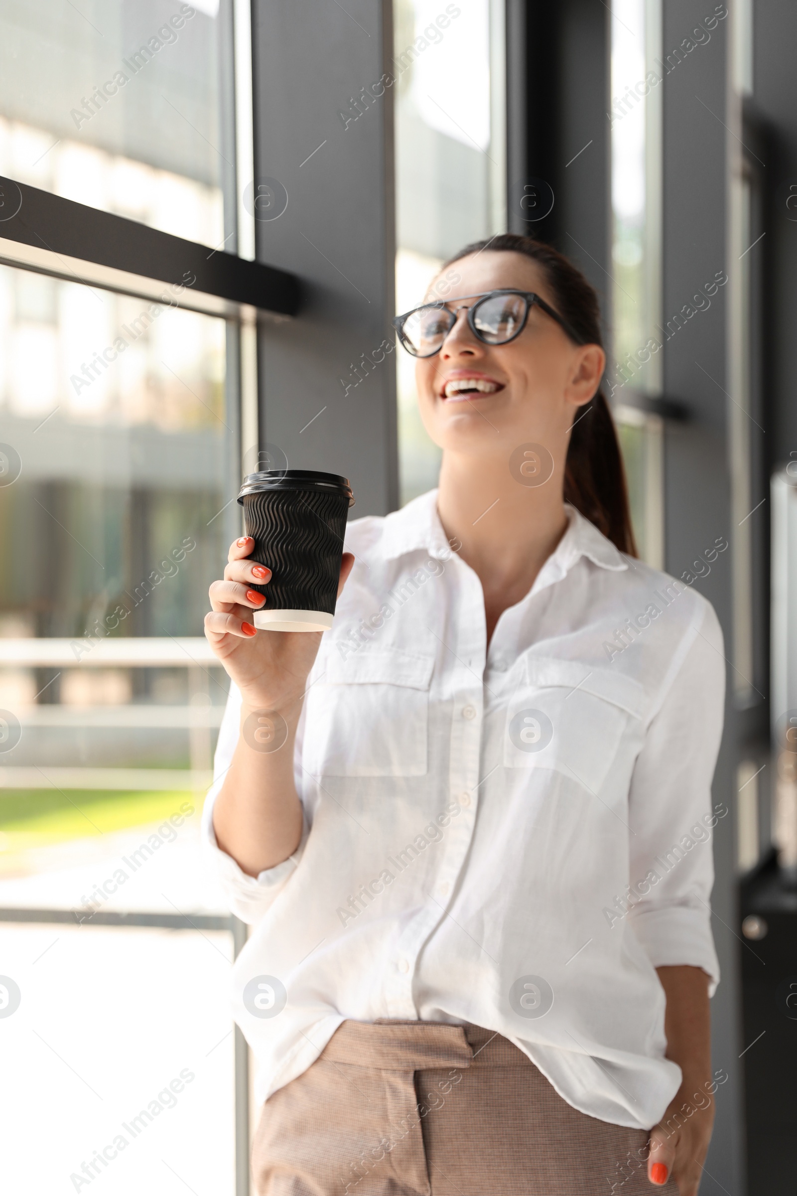 Photo of Portrait of female business trainer with cup of coffee indoors