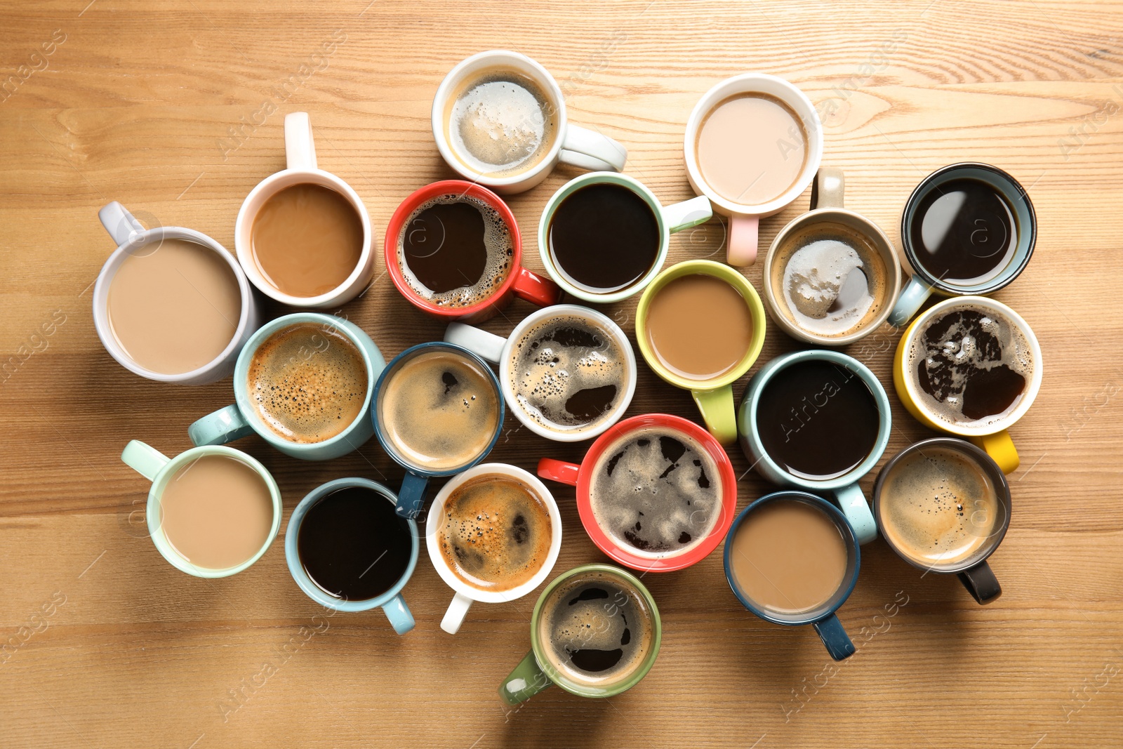 Photo of Flat lay composition with cups of coffee on wooden background. Food photography