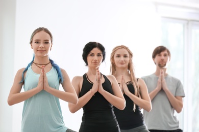 Group of people practicing yoga indoors