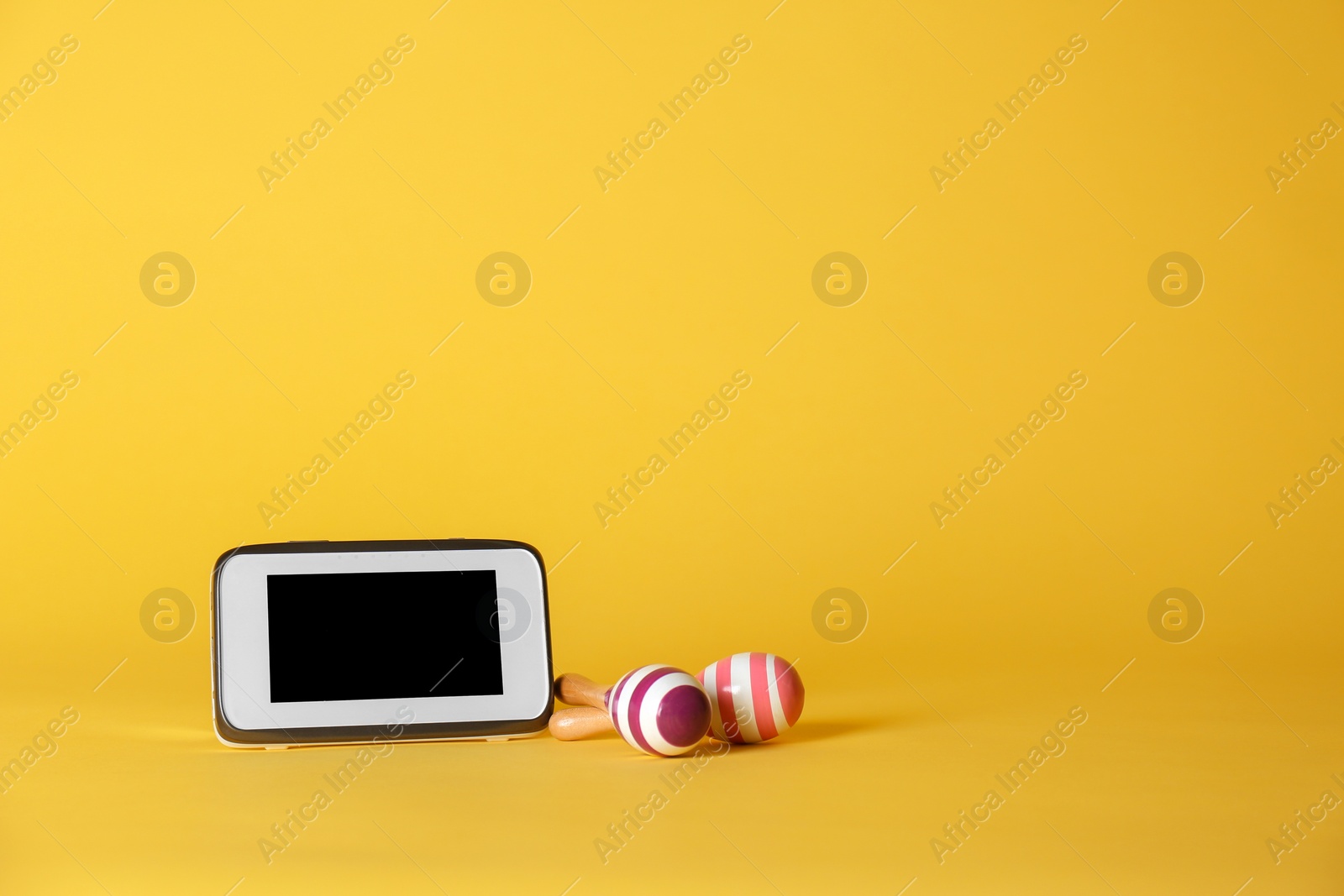 Photo of Modern monitor and rattles on color background, space for text. CCTV equipment
