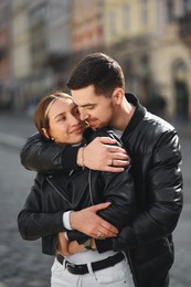 Lovely young couple together on city street. Romantic date