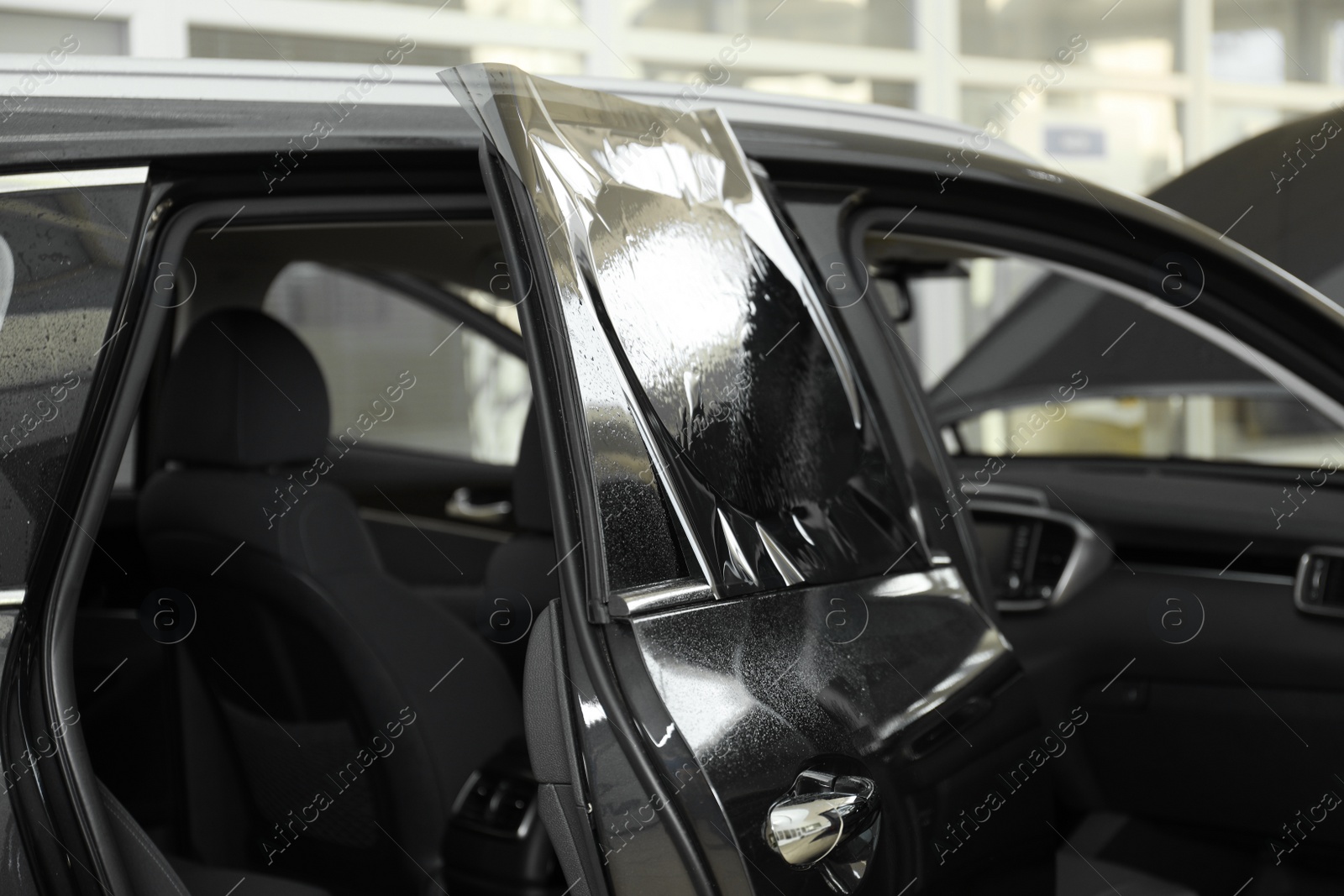 Photo of Car window covered with tinting foil, closeup