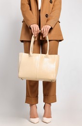 Photo of Young woman with stylish bag on white background, closeup