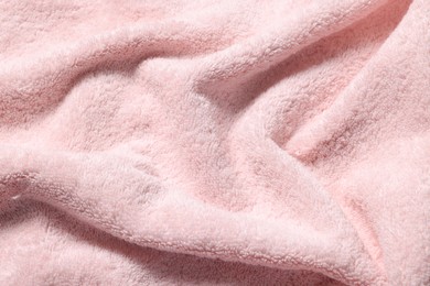 Texture of pink crumpled fabric as background, top view