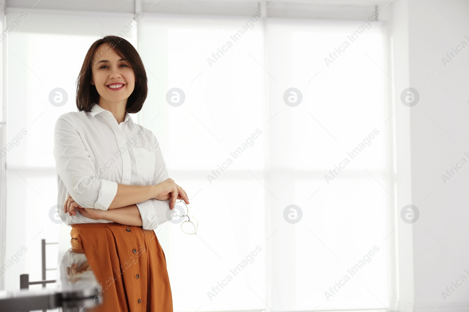 Photo of Happy mature businesswoman leaning on railing in office. Space for text