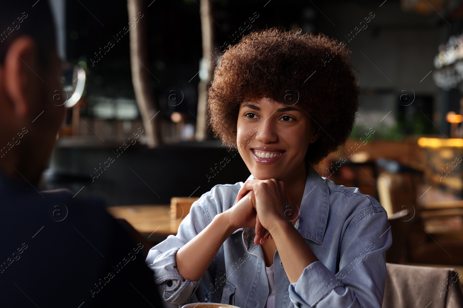 Photo of International dating. Lovely couple spending time together in cafe