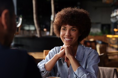 International dating. Lovely couple spending time together in cafe