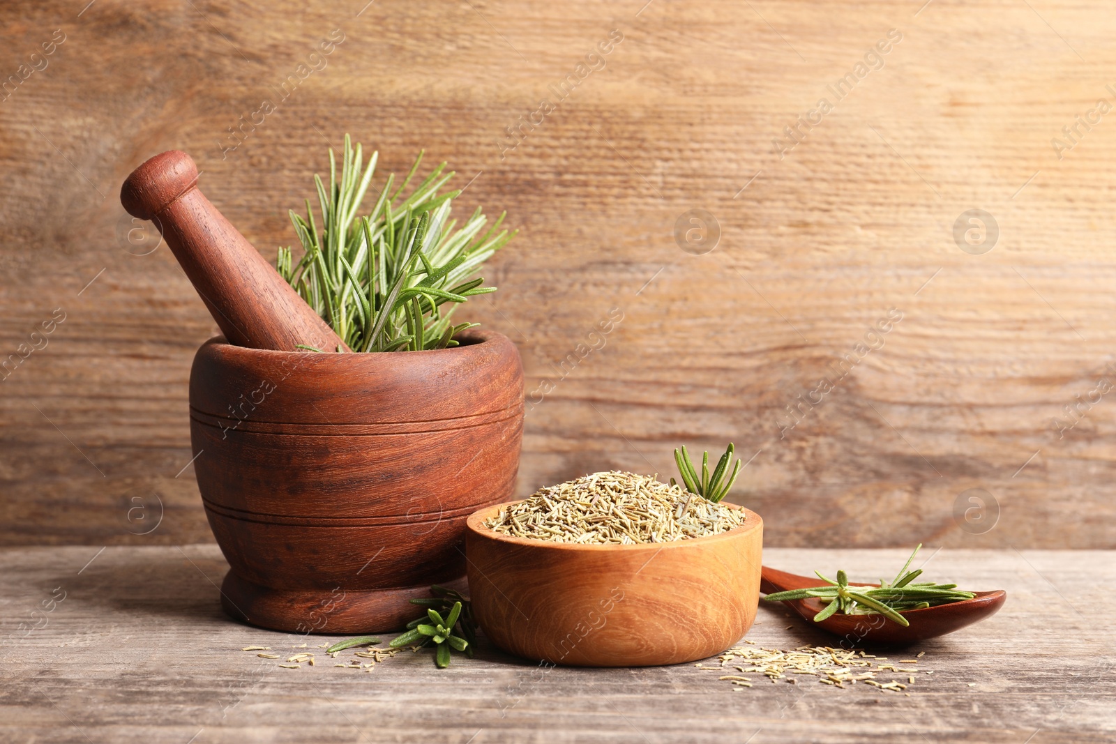 Photo of Fresh and dry rosemary on wooden table