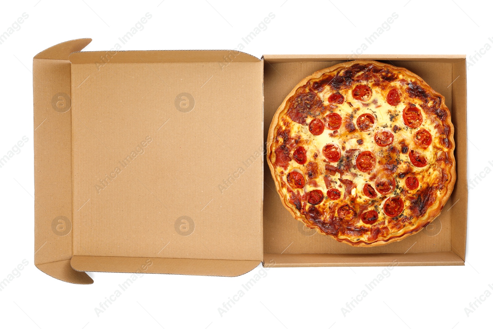 Photo of Delicious quiche with prosciutto and tomatoes in cardboard box isolated on white, top view. Food delivery