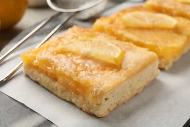 Tasty lemon bars on table, closeup view