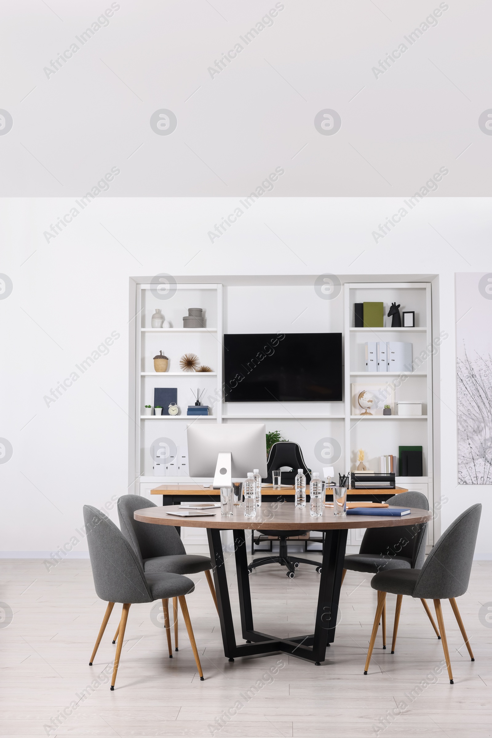 Photo of Stylish office with comfortable furniture and tv zone. Interior design