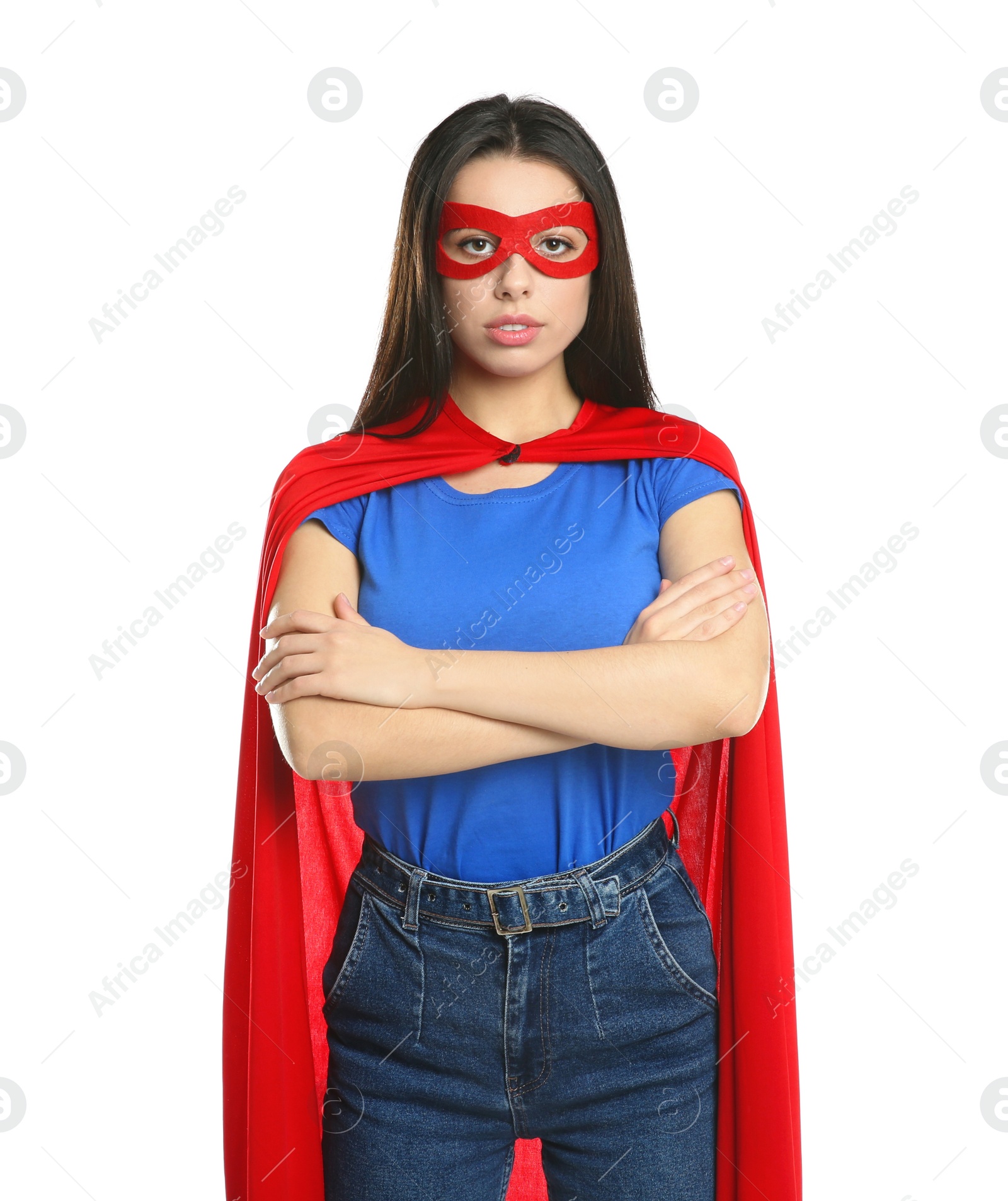 Photo of Confident young woman wearing superhero cape and mask on white background