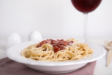 Photo of Delicious Carbonara pasta served on white table