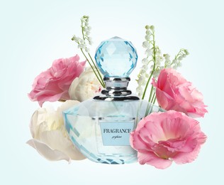 Bottle of luxury perfume and beautiful flowers on light blue background