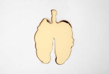 Photo of No smoking concept. Burned lungs shaped paper on beige background, top view