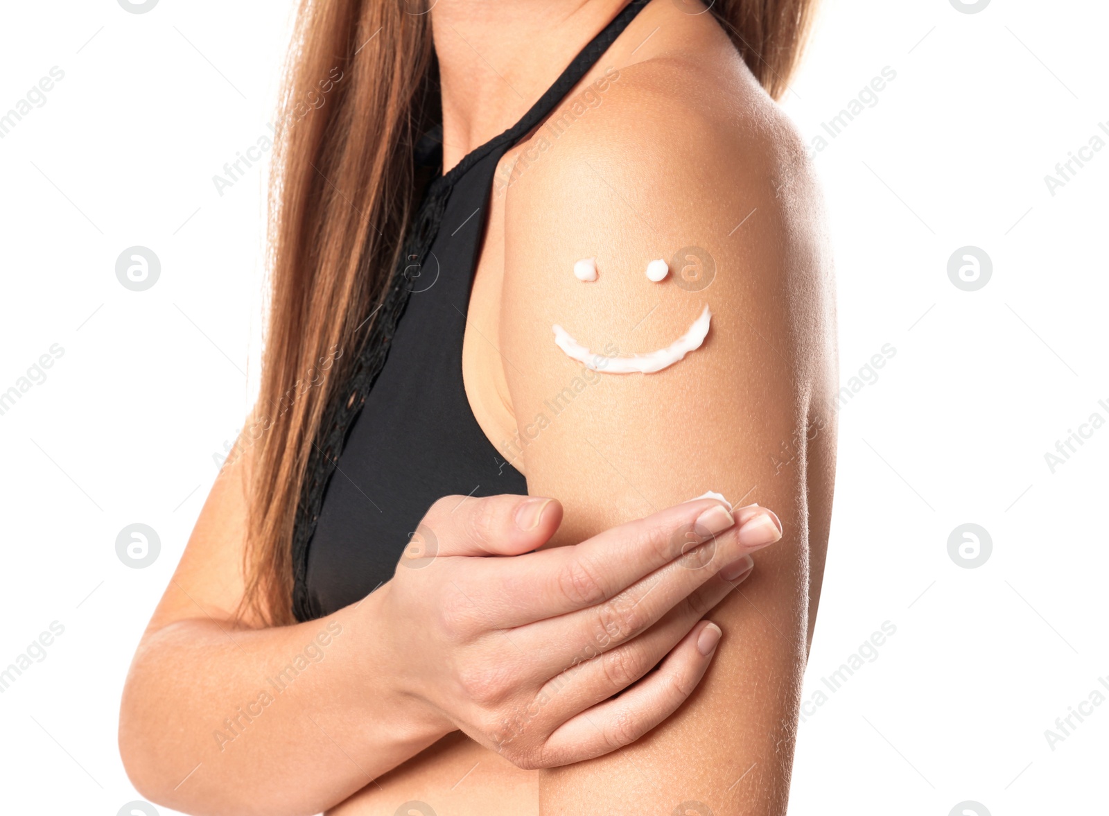 Photo of Woman with smiling face made of sun protection body cream on shoulder against white background, closeup