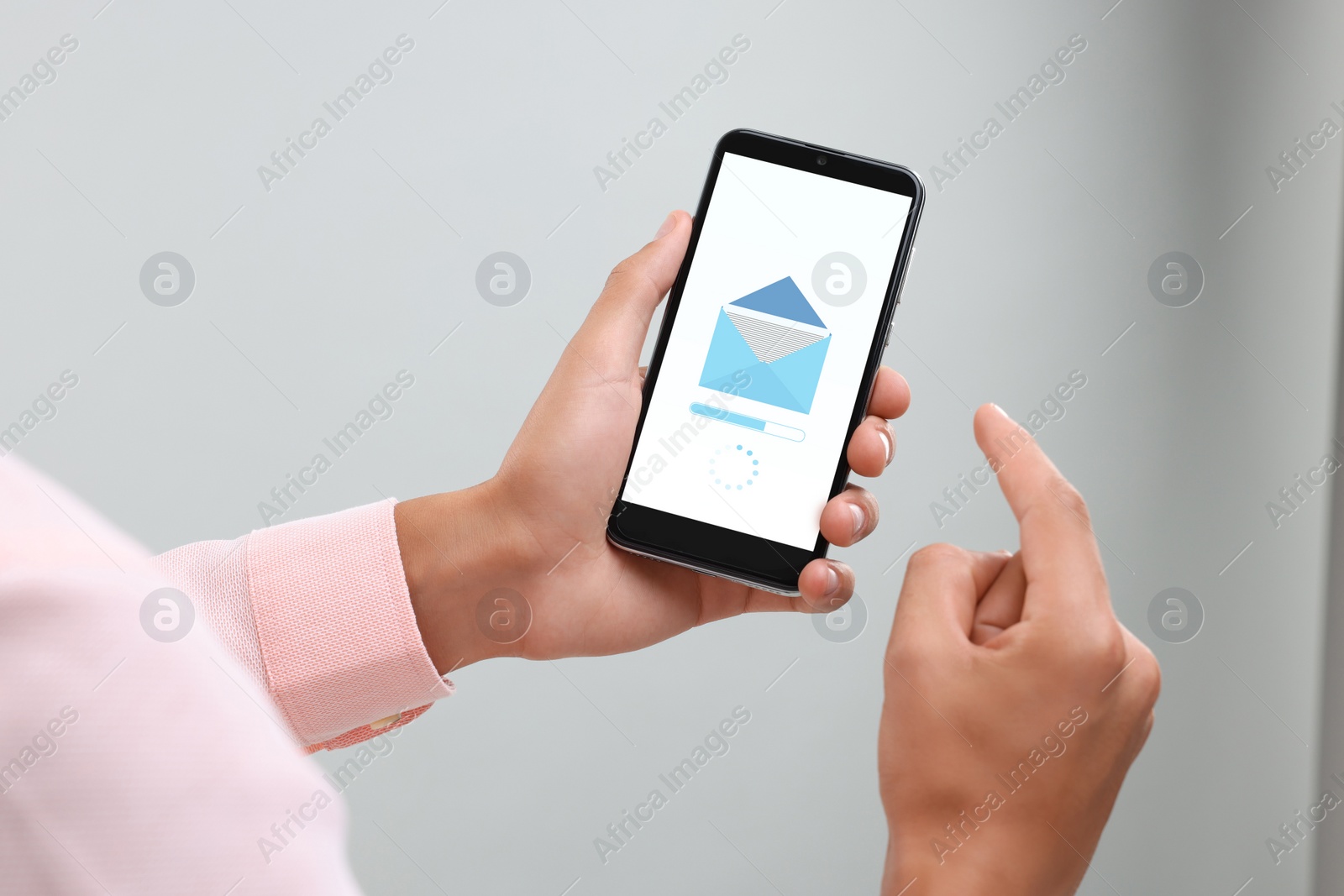 Image of Got new message. Man using smartphone on light grey background, closeup