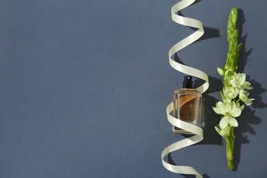 Beautiful composition with bottle of perfume on grey background, flat lay