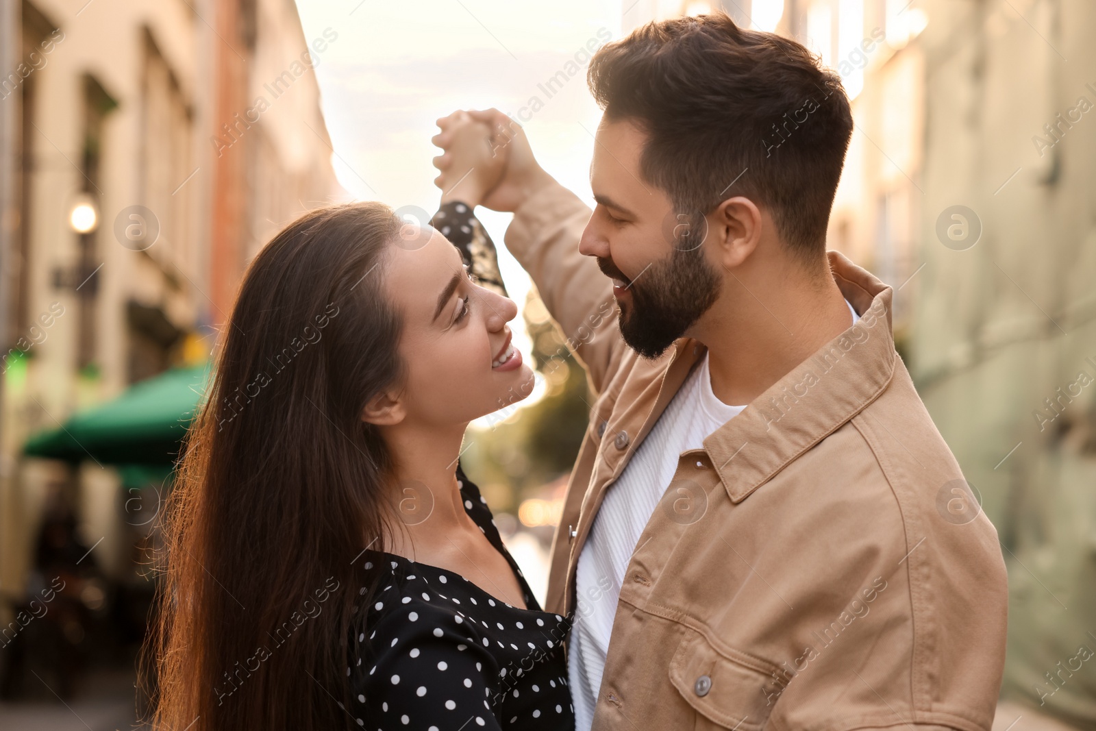 Photo of Lovely couple dancing together on city street