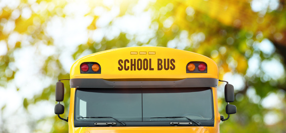 Image of Yellow school bus outdoors, closeup. Transport for students