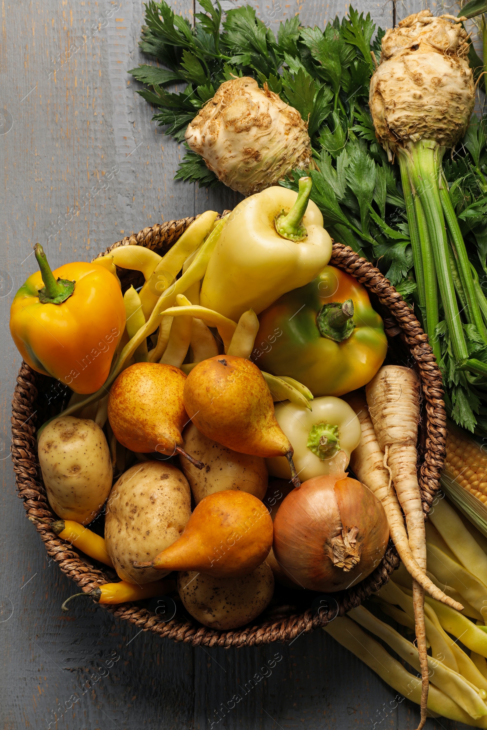 Photo of Different fresh ripe vegetables and fruits on grey wooden table, flat lay