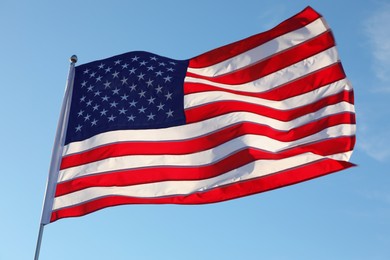 Photo of American flag fluttering outdoors on sunny day