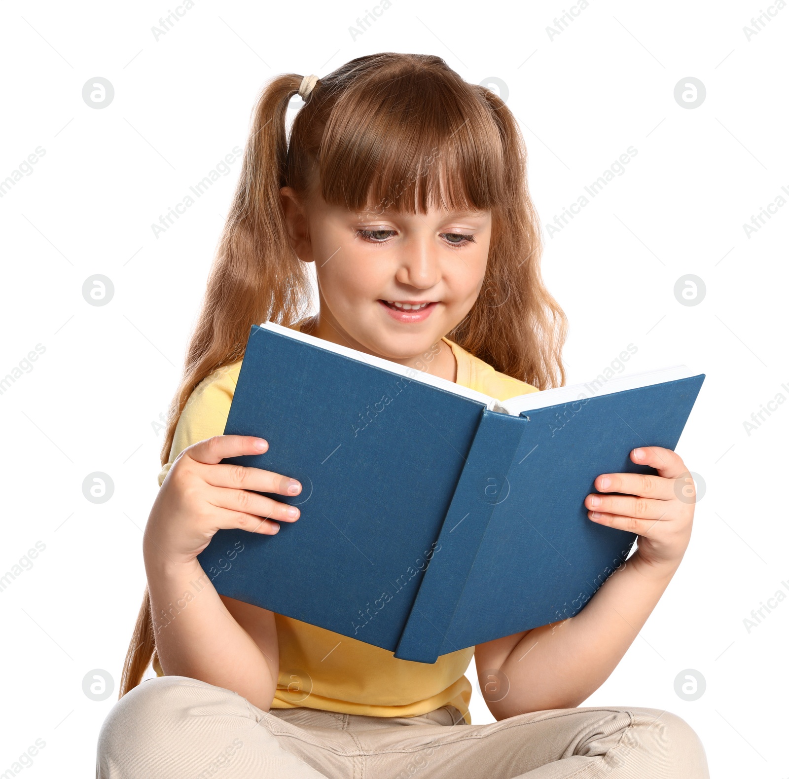 Photo of Portrait of cute little girl reading book on white background