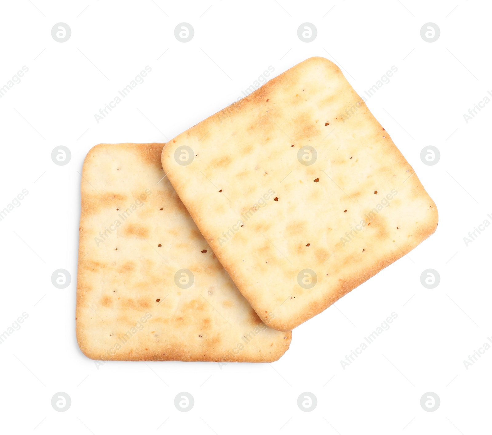 Photo of Tasty crispy square crackers isolated on white, top view