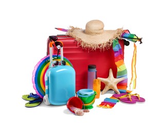 Photo of Suitcases, straw hat, inflatable ring and other beach accessories isolated on white
