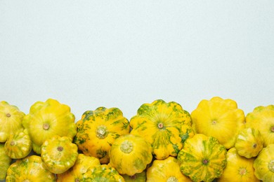Photo of Fresh ripe pattypan squashes on light background, flat lay. Space for text