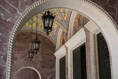 Photo of View of beautiful arch and lanterns of cathedral indoors