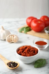 Photo of Red curry paste and ingredients on white marble table