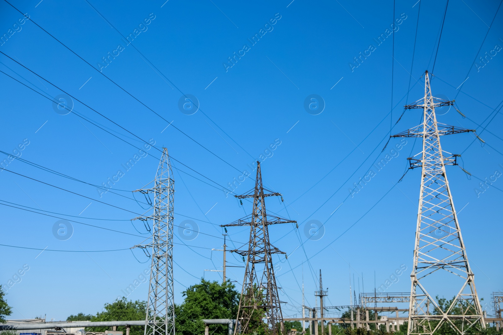 Photo of Modern high voltage towers against blue sky