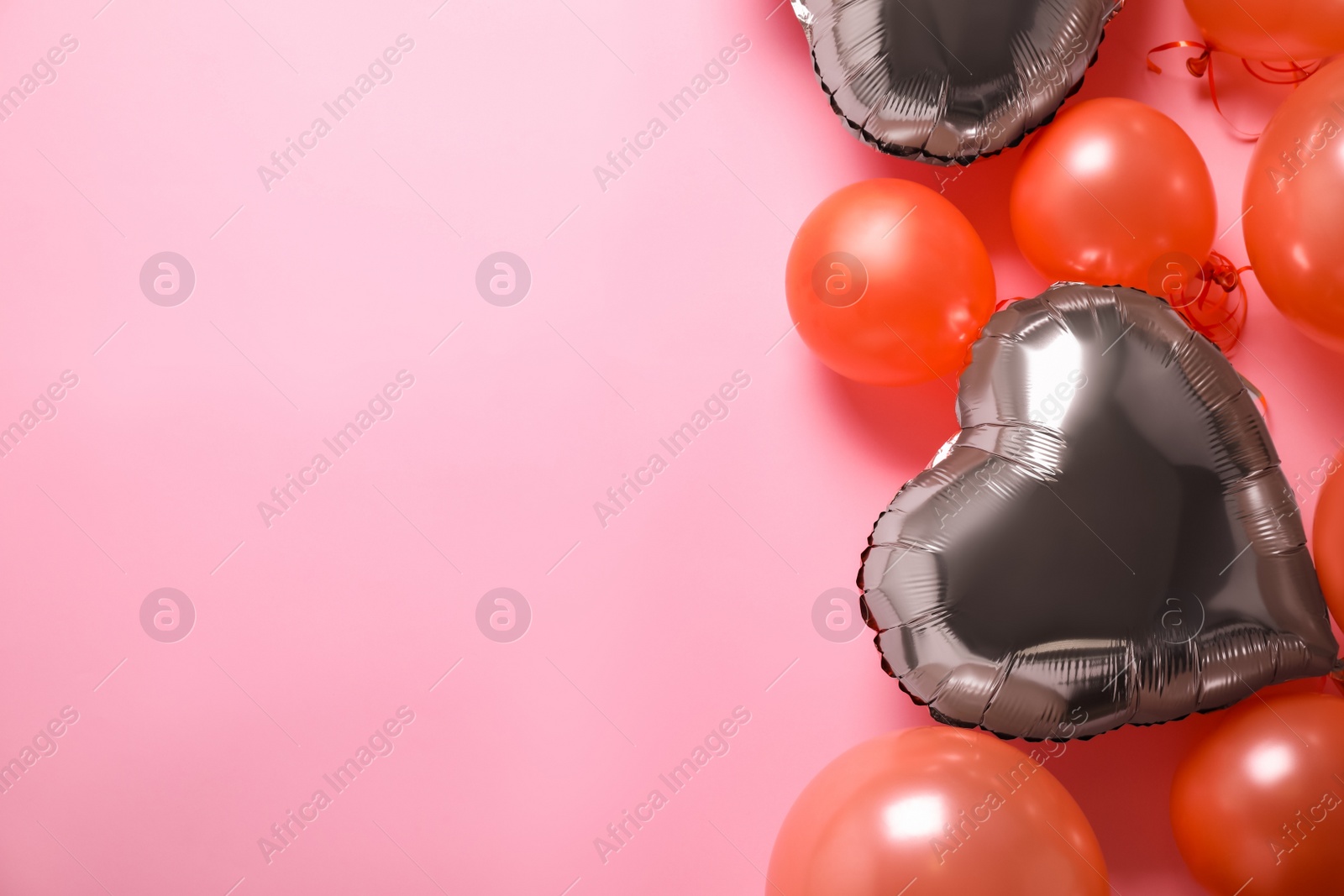 Photo of Colorful balloons on pink background, flat lay. Space for text