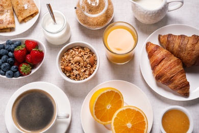 Photo of Buffet service. Tasty breakfast served on table, flat lay