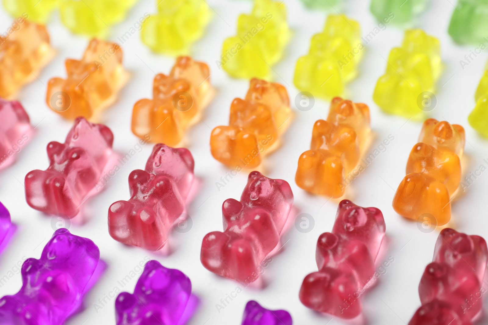 Photo of Many delicious little jelly bears on white background