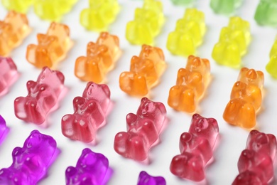 Photo of Many delicious little jelly bears on white background