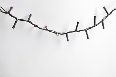 Beautiful Christmas lights on white background, top view