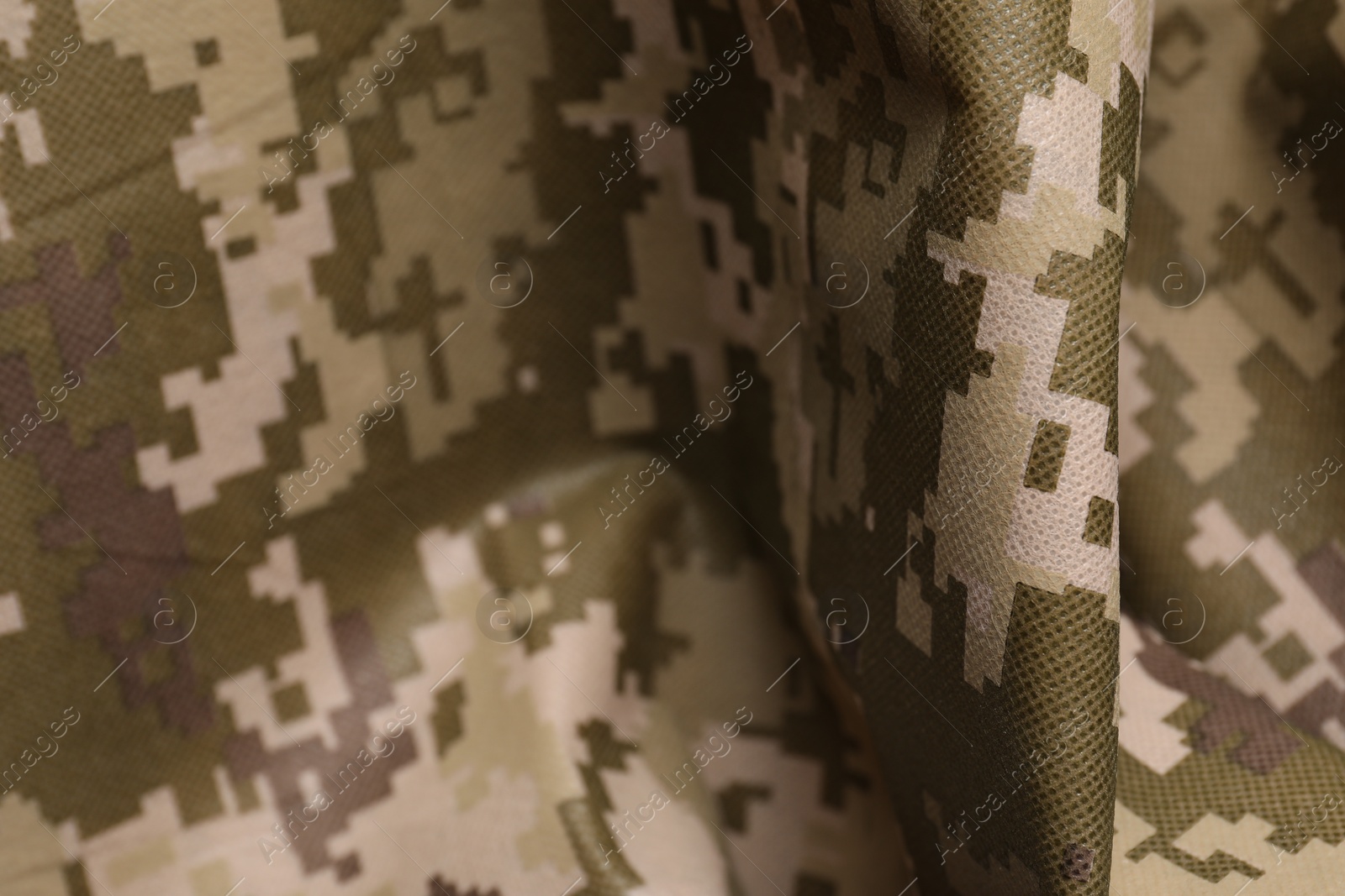 Photo of Texture of crumpled camouflage fabric as background, closeup