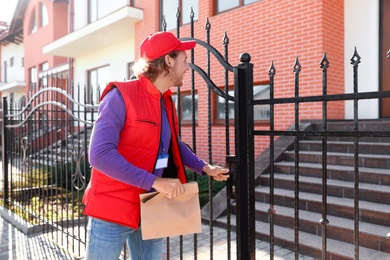 Male courier delivering food in city on sunny day