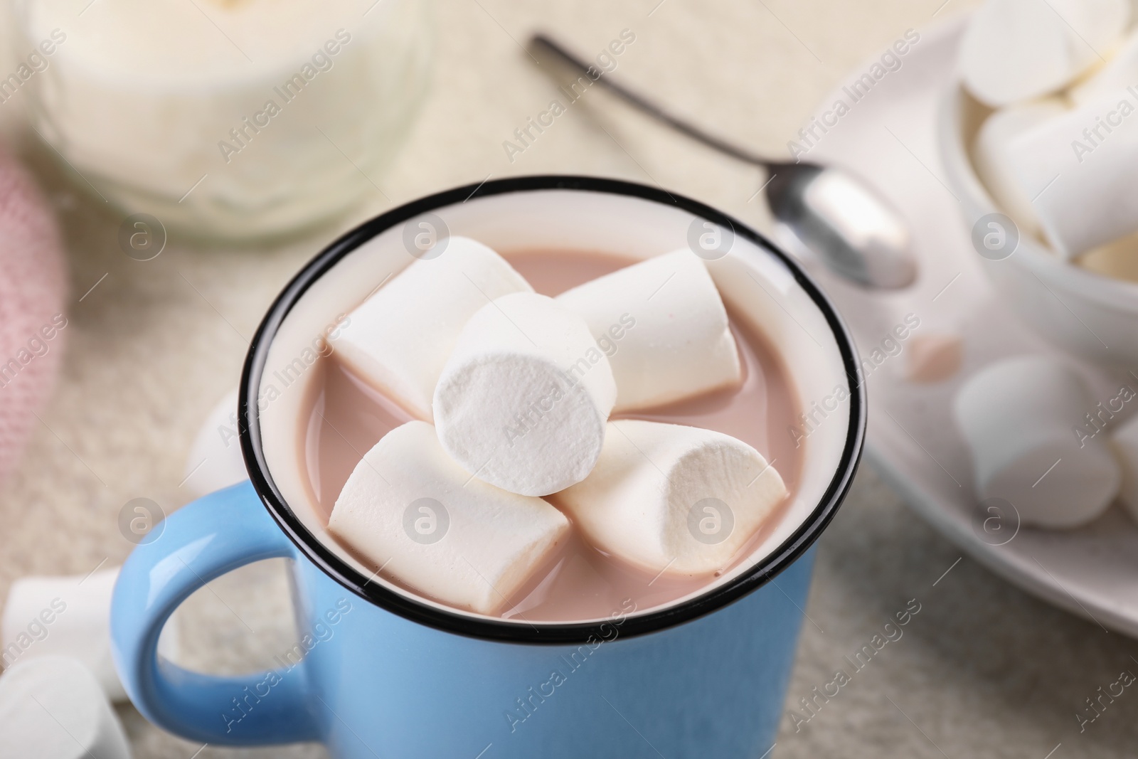 Photo of Cup of aromatic hot chocolate with marshmallows served on table, closeup