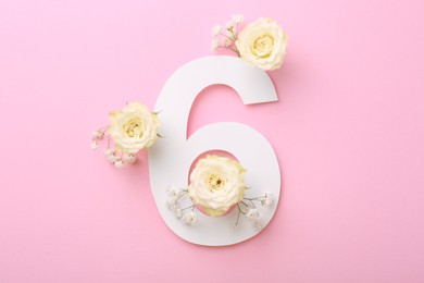 Photo of Paper number 6 and beautiful flowers on pink background, flat lay