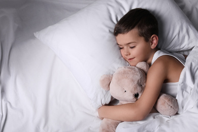 Little boy sleeping with teddy bear at home. Bedtime