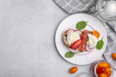 Photo of Delicious sandwich with burrata cheese, ham, radish and tomatoes served on light grey table, flat lay. Space for text