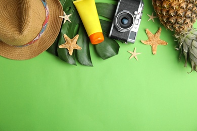 Photo of Flat lay composition with beach objects on green background. Space for text